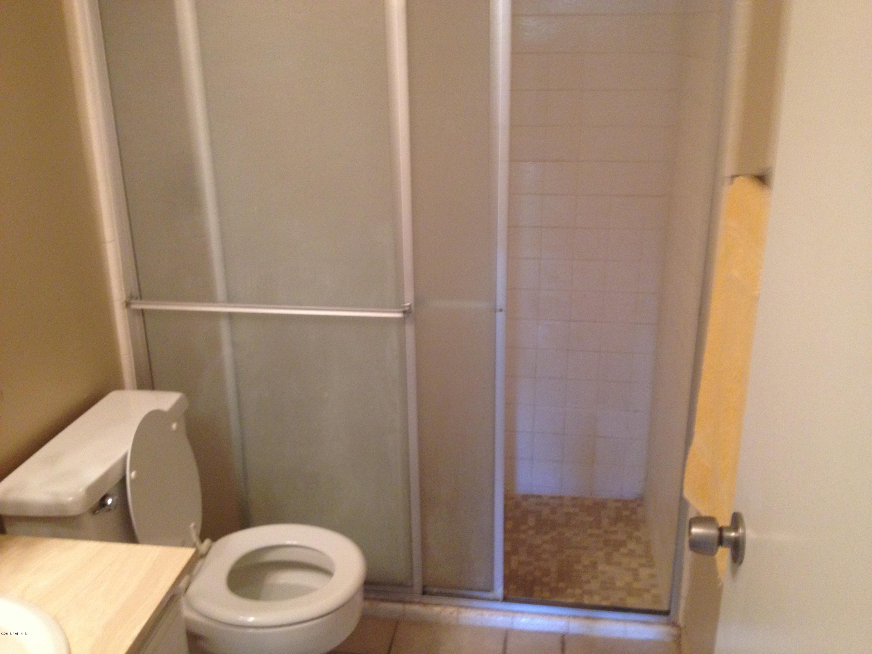 625 South Prudence Road, Unit 102 Tucson, AZ 85710 - Photo 14 of 25 a white toilet sitting next to a shower