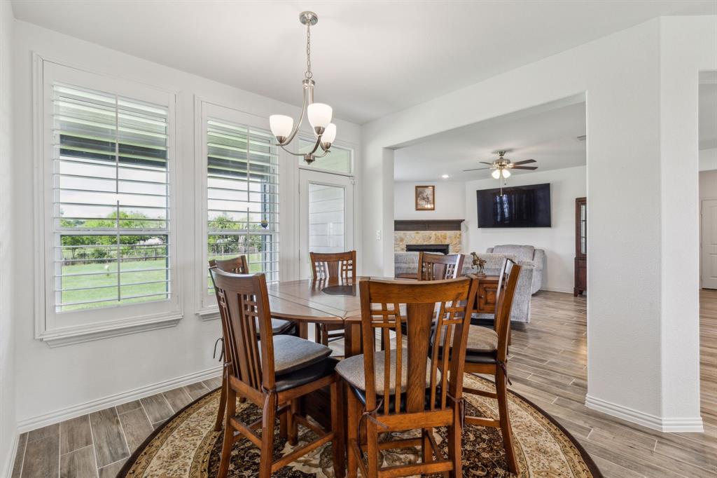 2410 Black Jack Oak Road Terrell, TX 75161 - Photo 14 of 31 Dining area with healthy amount of natural light, light wood finished floors, baseboards, and a fireplace