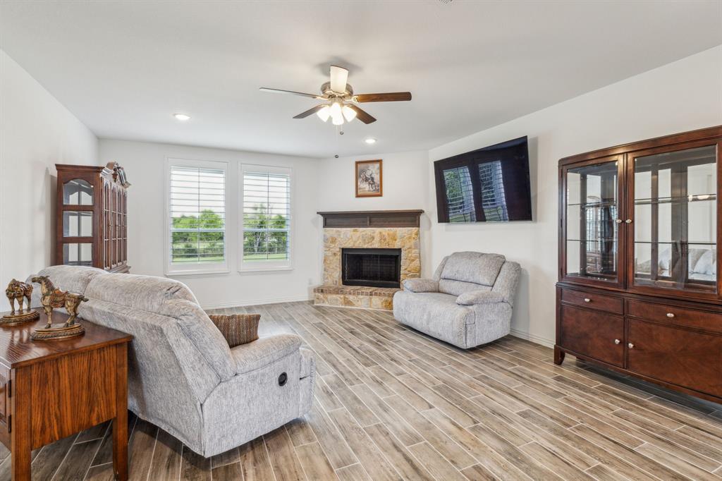 2410 Black Jack Oak Road Terrell, TX 75161 - Photo 17 of 31 Living area with ceiling fan, baseboards, wood finished floors, a stone fireplace, and recessed lighting