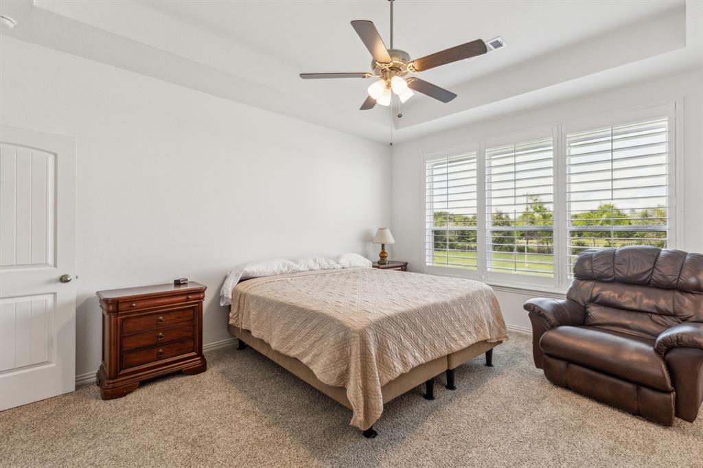 2410 Black Jack Oak Road Terrell, TX 75161 - Photo 19 of 31 Bedroom with carpet floors, a raised ceiling, baseboards, and ceiling fan