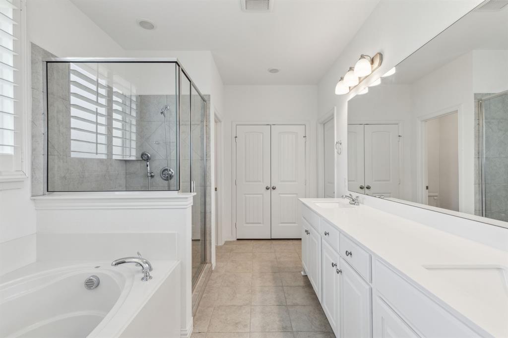 2410 Black Jack Oak Road Terrell, TX 75161 - Photo 20 of 31 Full bathroom featuring a shower stall, double vanity, a garden tub, and tile patterned flooring