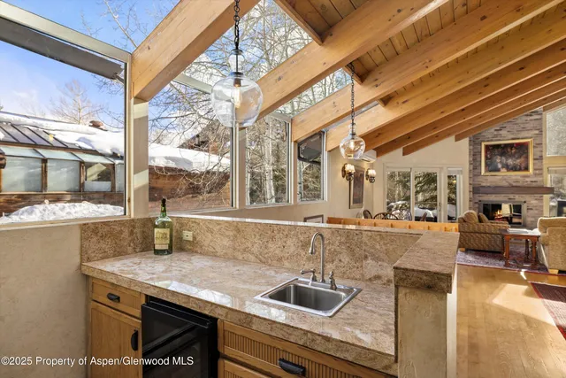 a kitchen with a stove and a view of living room
