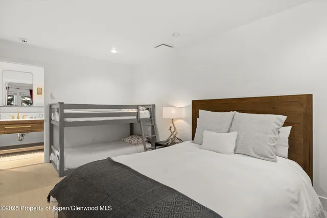 a bedroom with a bed and a lamp