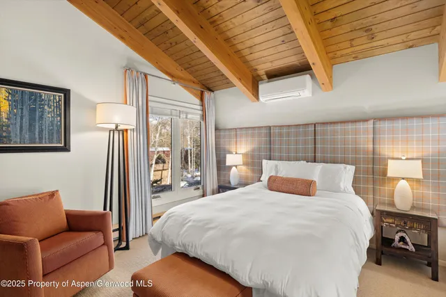 a bedroom with a bed couch and window