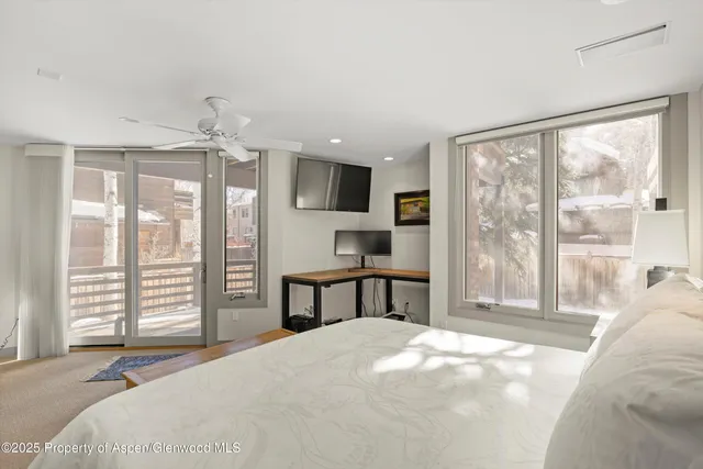 a bedroom with a large bed and a large window