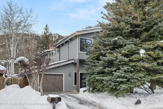 a view of a house with a tree