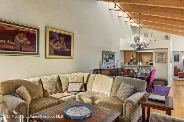 a living room with furniture and a chandelier