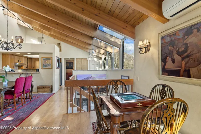 a dining room with furniture and wooden floor