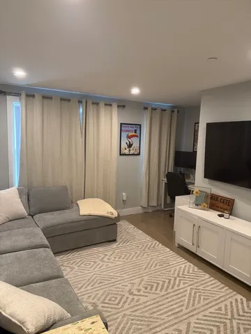 a bedroom with a large bed and a flat screen tv