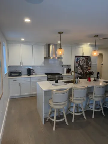 a kitchen with a dining table chairs and view kitchen