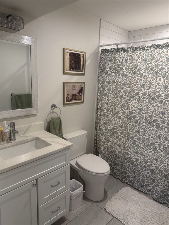 7 Saco Street, Unit 5 Boston, MA 02122 - Photo 7 of 15 a bathroom with a sink a toilet and shower