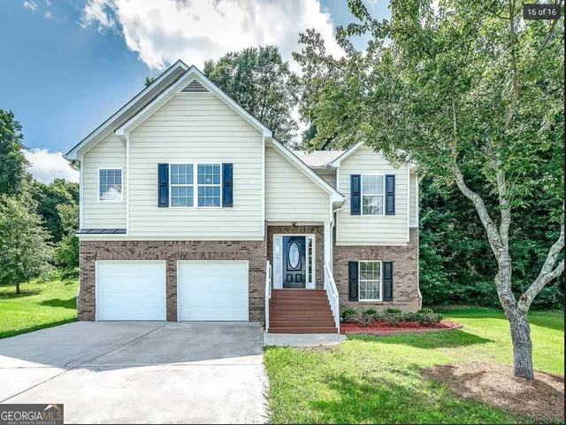 a front view of a house with a yard and garage