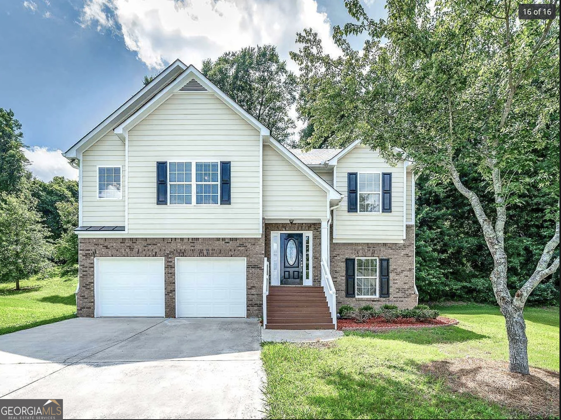 a front view of a house with a yard and garage