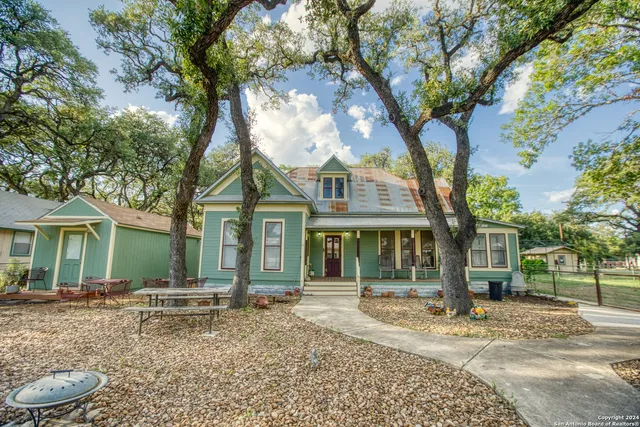 a house that has a tree in front of it