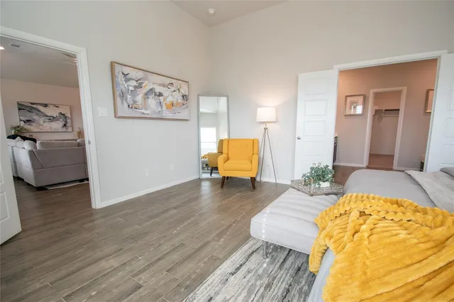 a bedroom with furniture and a lamp