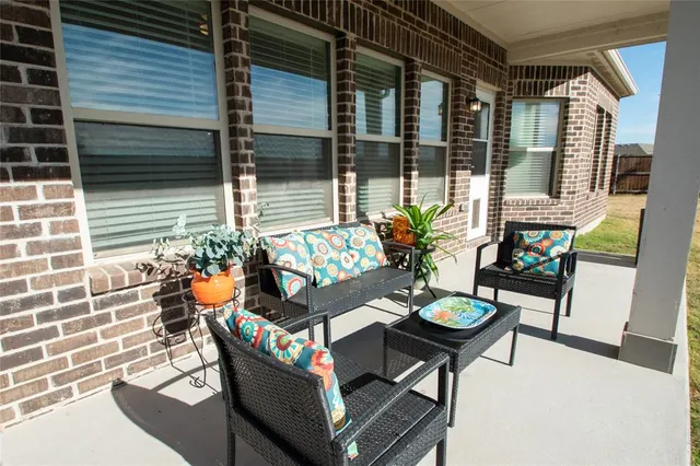 a front view of house with yard and trees in the background