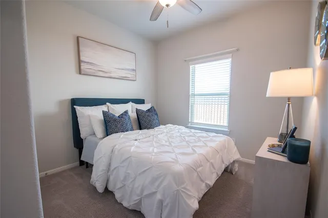 a bed sitting in a bedroom next to a lamp