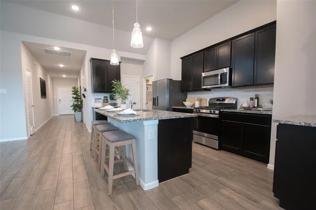 a kitchen with a sink cabinets and stainless steel appliances