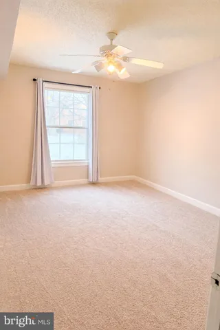 an empty room with windows and entrance