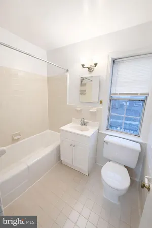 a bathroom with a sink a toilet and bathtub