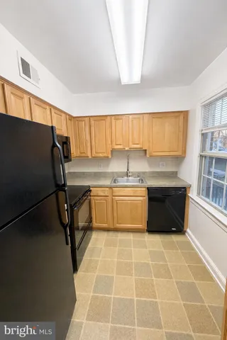 a kitchen with a sink a counter and cabinets