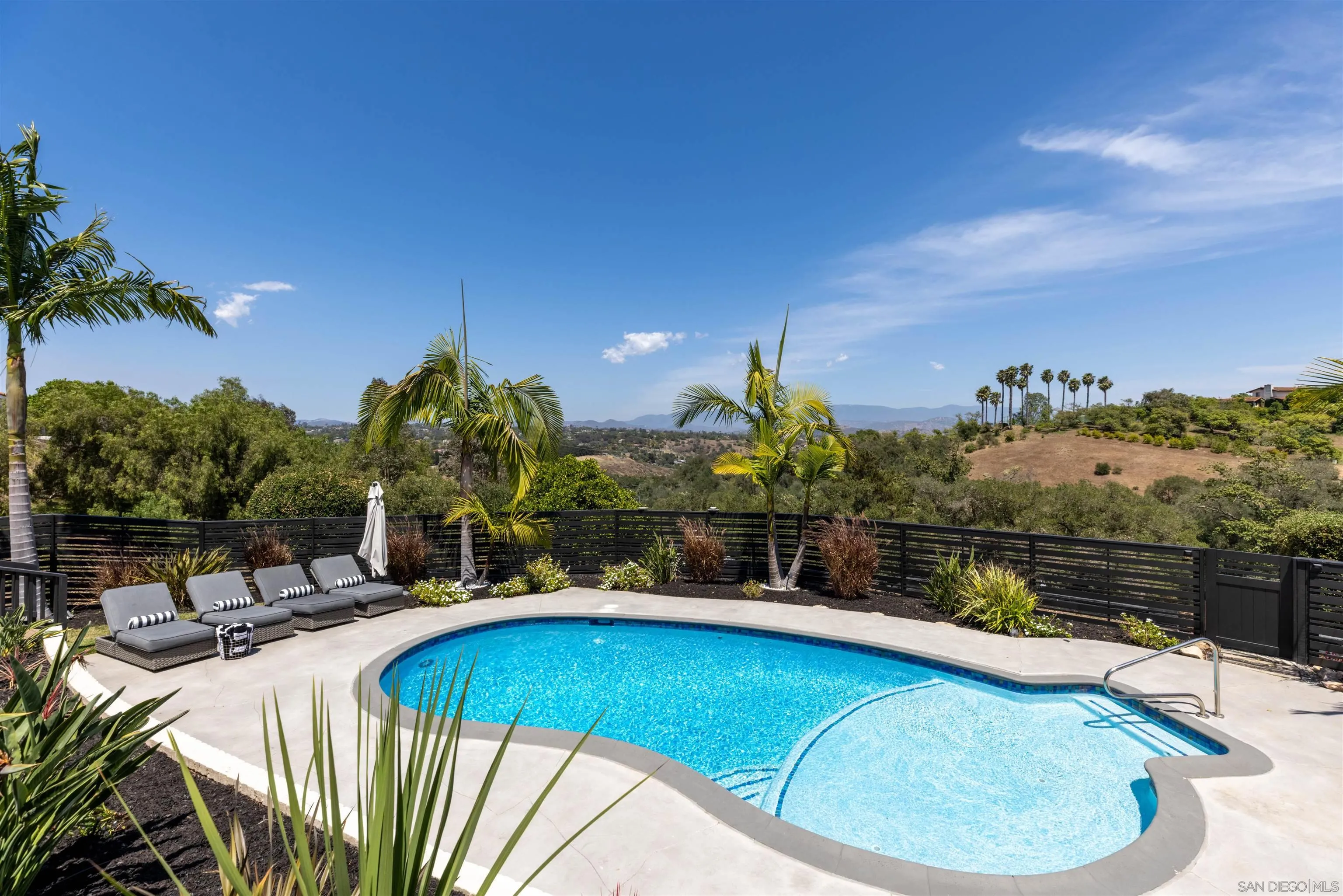 521 Rancho Camino Fallbrook, CA 92028 - Photo 54 of 72 a view of a swimming pool with a chairs