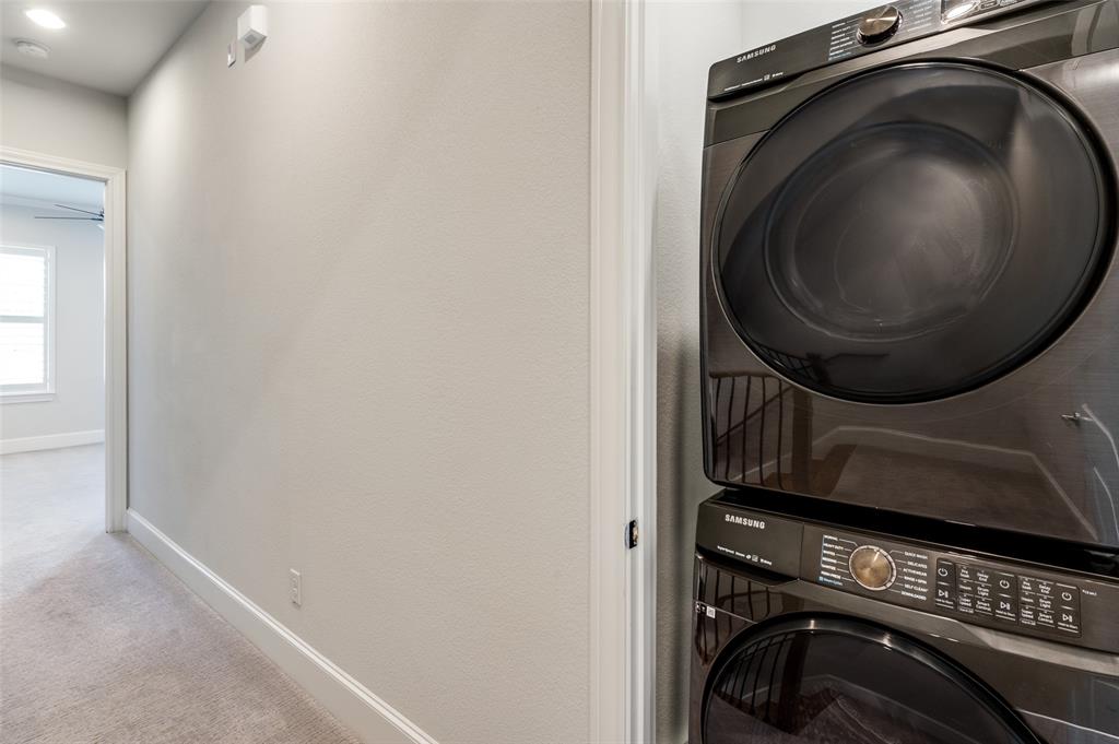 5421 Patterson Street Irving, TX 75039 - Photo 28 of 32 Dedicated laundry area featuring a stacked washer and dryer unit