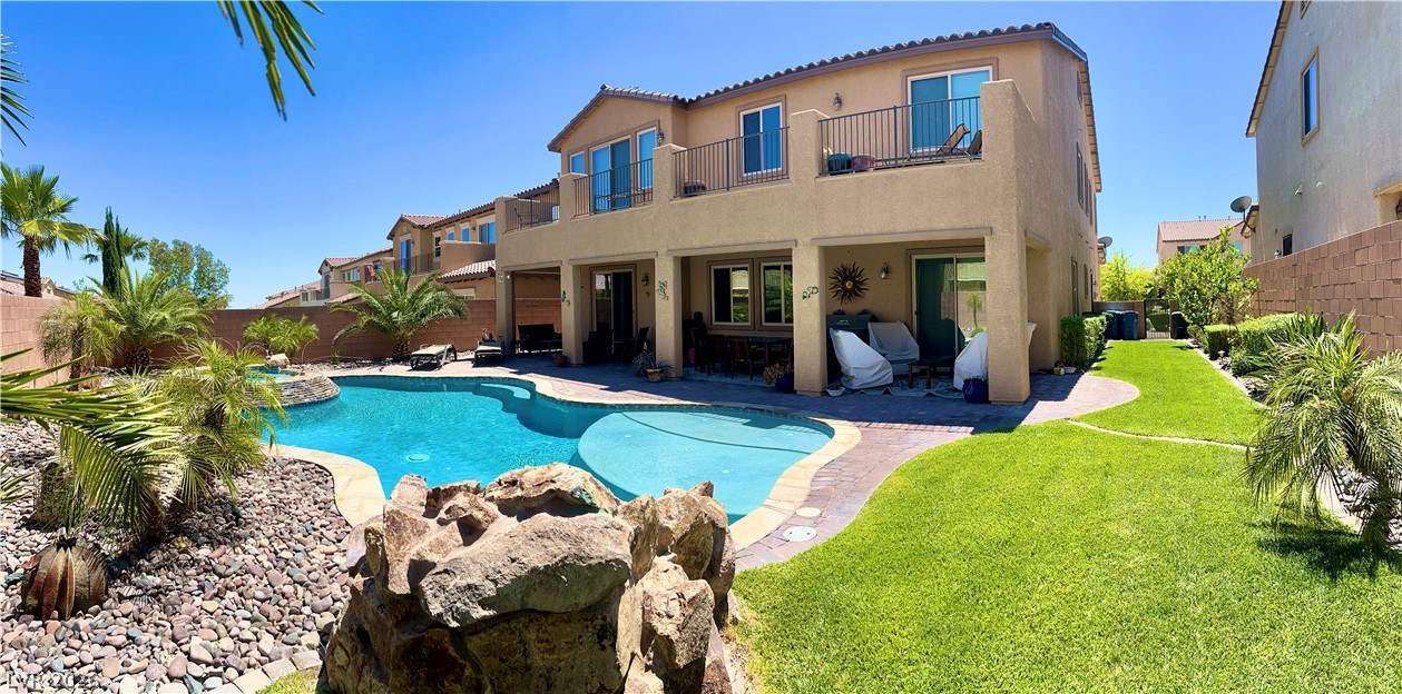 9724 University Ridge Avenue Las Vegas, NV 89149 - Photo 23 of 61 An inviting backyard oasis offers a sparkling pool and lush landscaping.