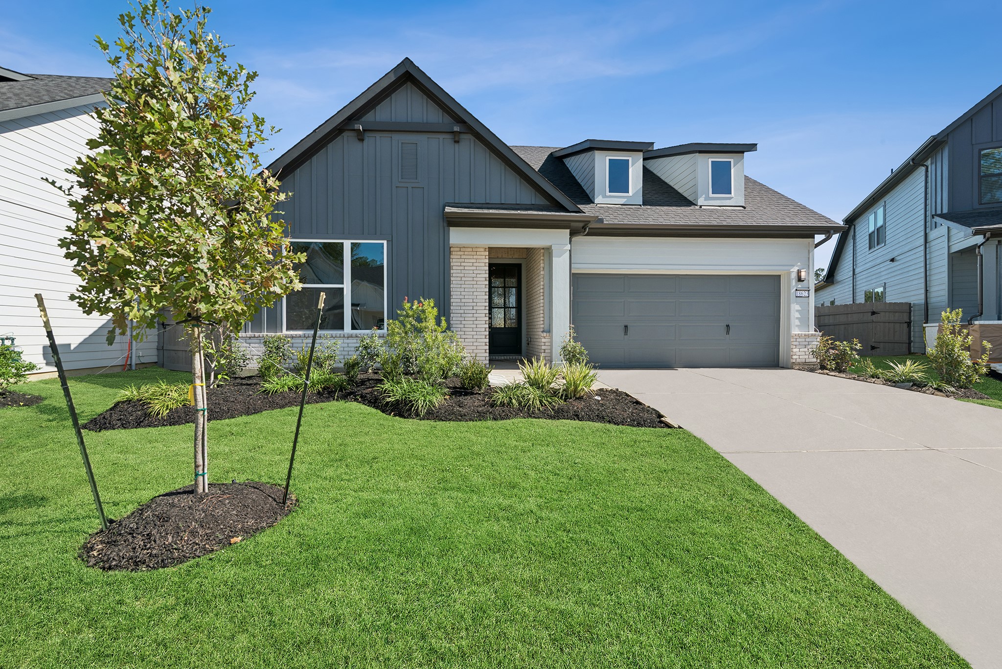 18623 Rumba Court Conroe, TX 77302 - Photo 2 of 48 a front view of a house with a garden