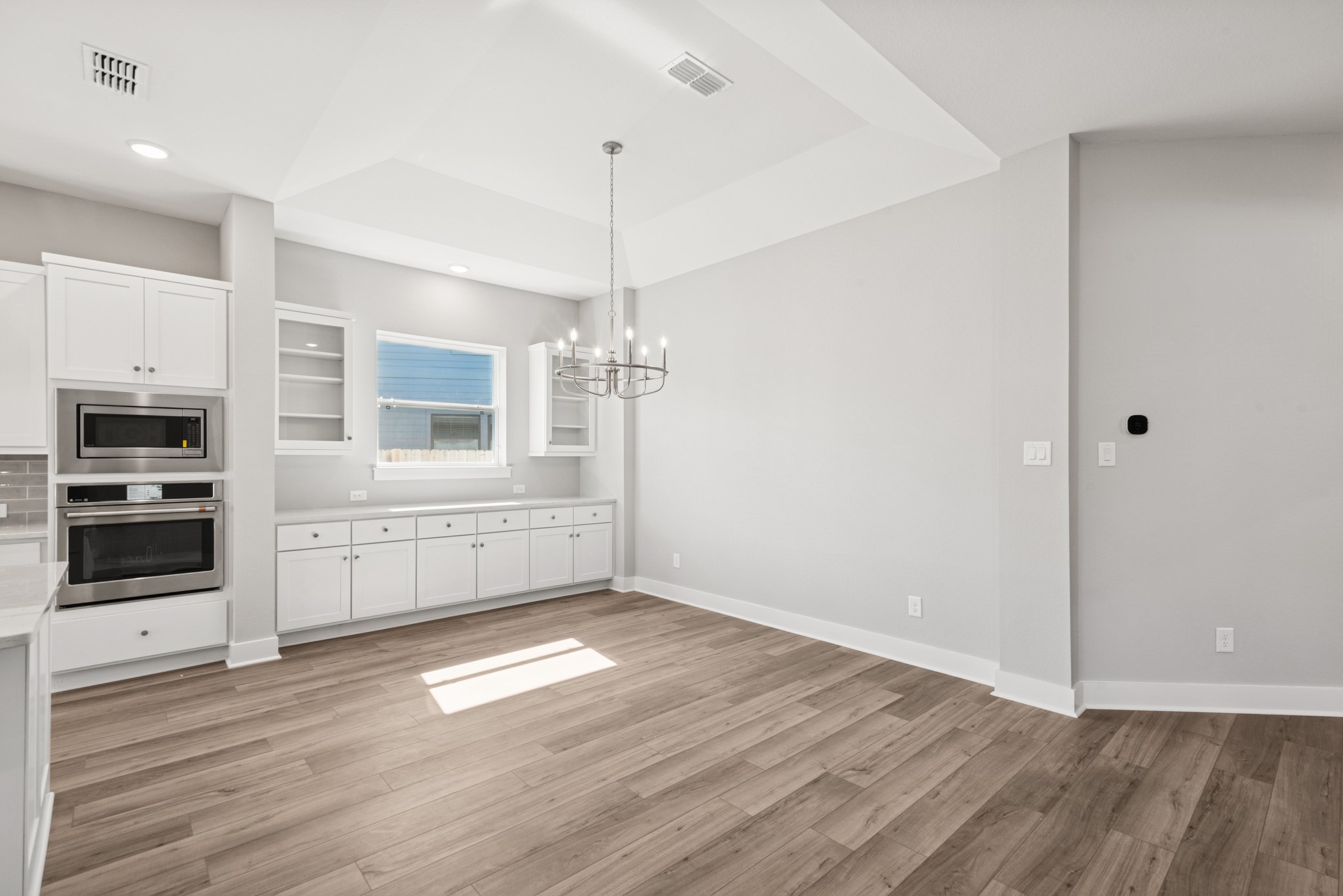 18623 Rumba Court Conroe, TX 77302 - Photo 26 of 48 a view of an empty room with a window and a kitchen