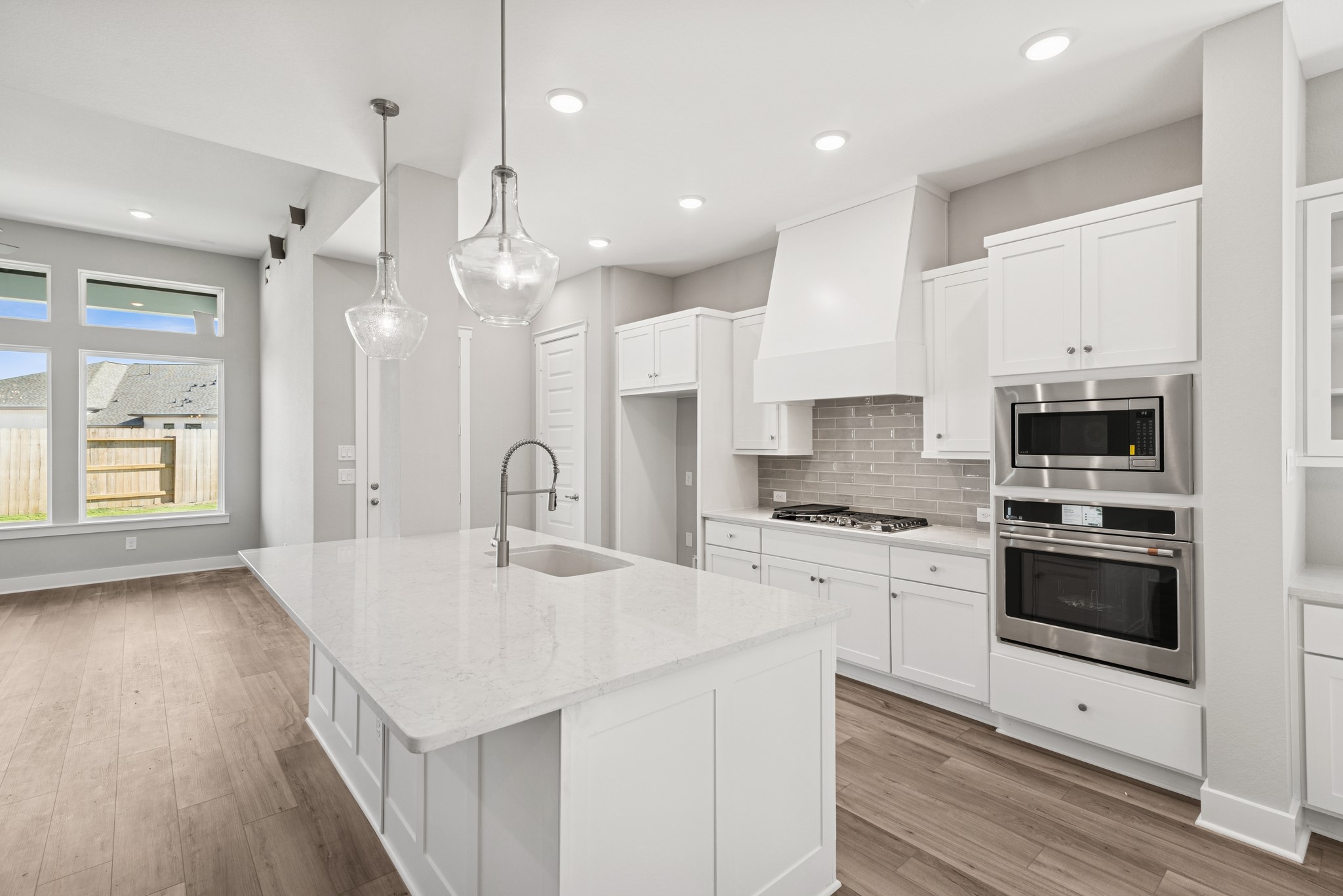 18623 Rumba Court Conroe, TX 77302 - Photo 29 of 48 a kitchen with stainless steel appliances kitchen island a refrigerator sink and stove