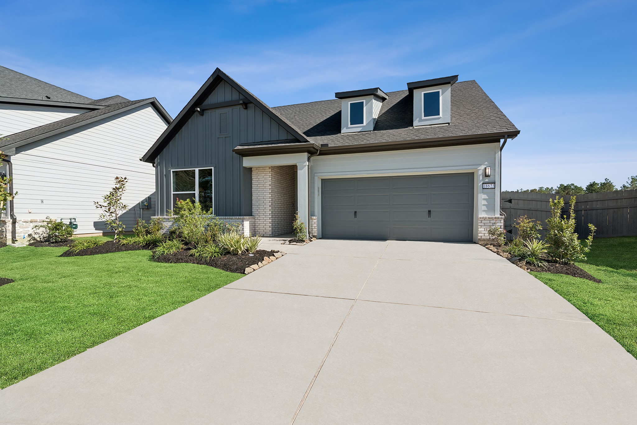 18623 Rumba Court Conroe, TX 77302 - Photo 3 of 48 a front view of a house with a yard and garage