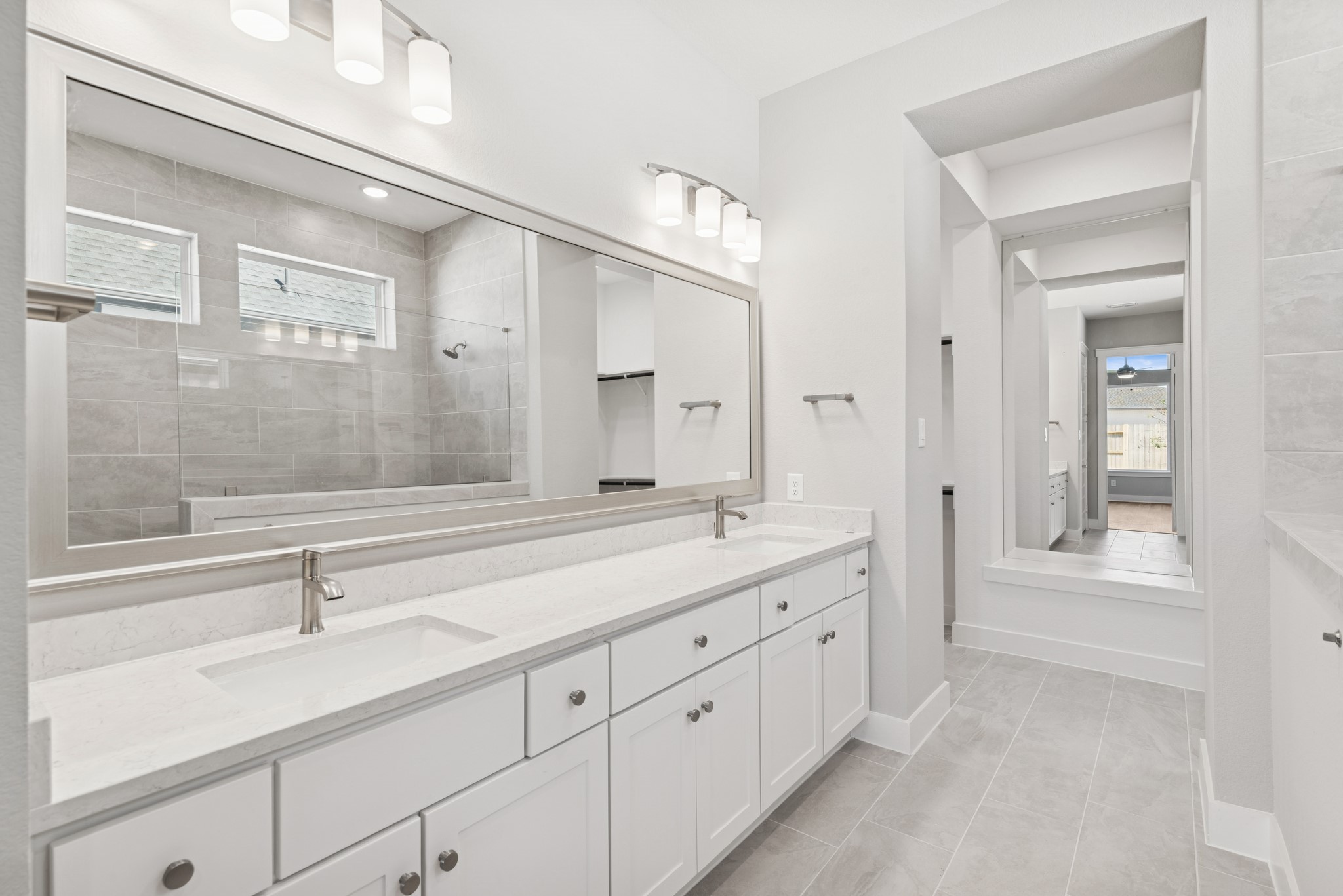 18623 Rumba Court Conroe, TX 77302 - Photo 40 of 48 a spacious bathroom with double sink a two mirror a glass door and shower