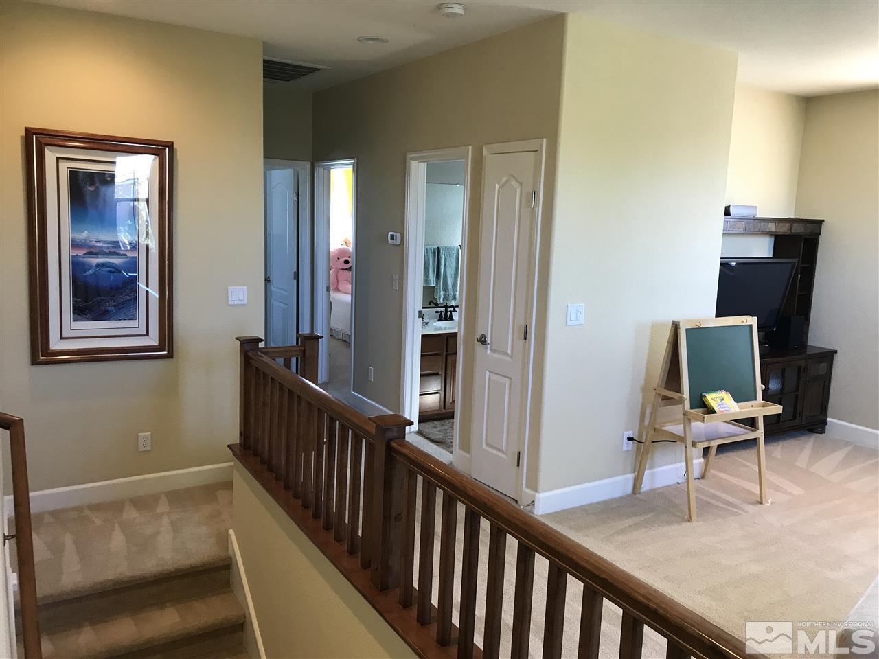 495 Terracina Way Reno, NV 89521 - Photo 11 of 25 a view of a hallway with workspace and mirror