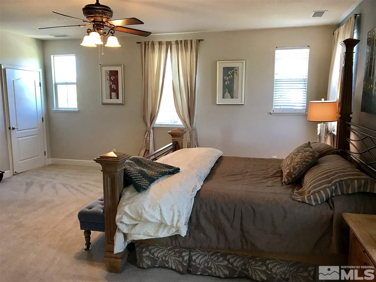 495 Terracina Way Reno, NV 89521 - Photo 15 of 25 a bedroom with a bed and a chandelier