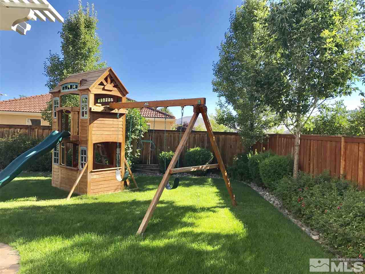 495 Terracina Way Reno, NV 89521 - Photo 24 of 25 a view of a backyard with a slide and a child swing