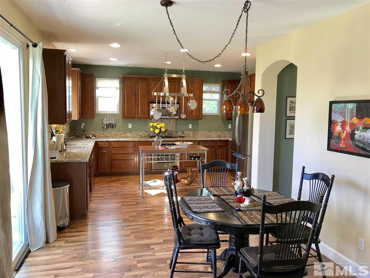 495 Terracina Way Reno, NV 89521 - Photo 5 of 25 a view of a dining room with furniture and wooden floor