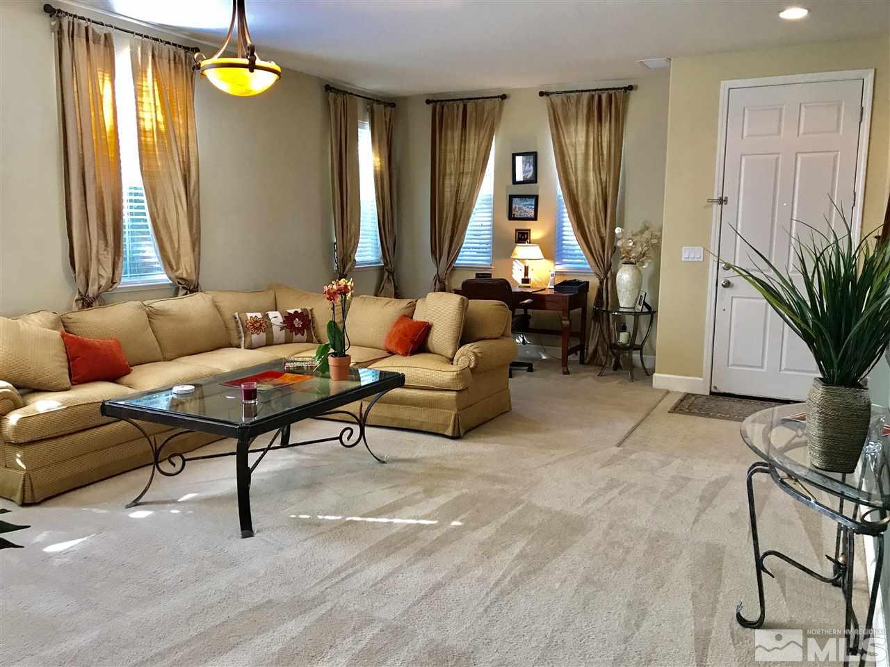 495 Terracina Way Reno, NV 89521 - Photo 9 of 25 a living room with furniture a window and a flat screen tv