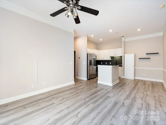 a kitchen with stainless steel appliances a refrigerator and microwave
