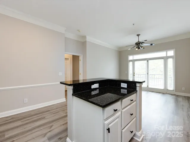a kitchen with granite countertop a sink and cabinets