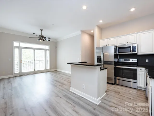 a kitchen with stainless steel appliances a refrigerator and a stove top oven