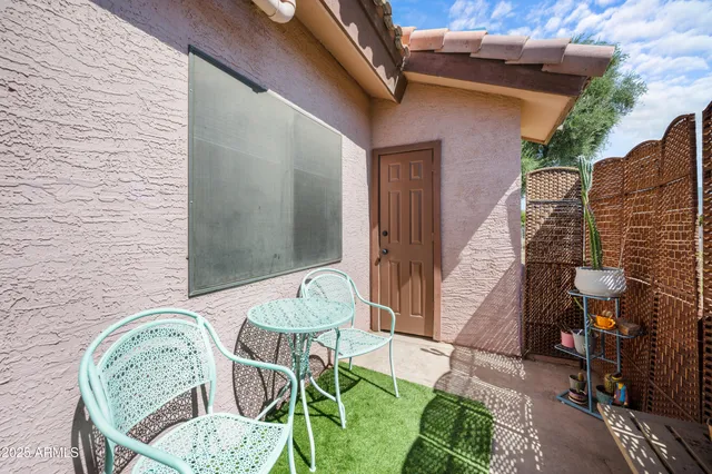 a balcony with table and chairs