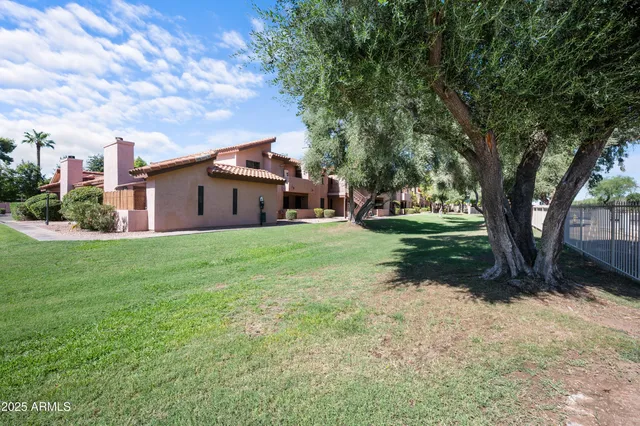 a front view of a house with a garden and yard