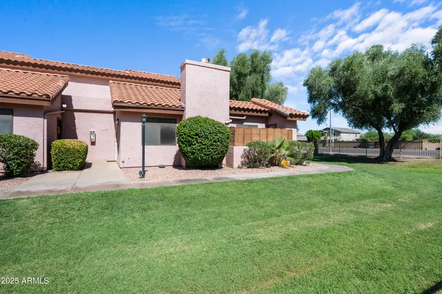 a front view of a house with a yard and a garage