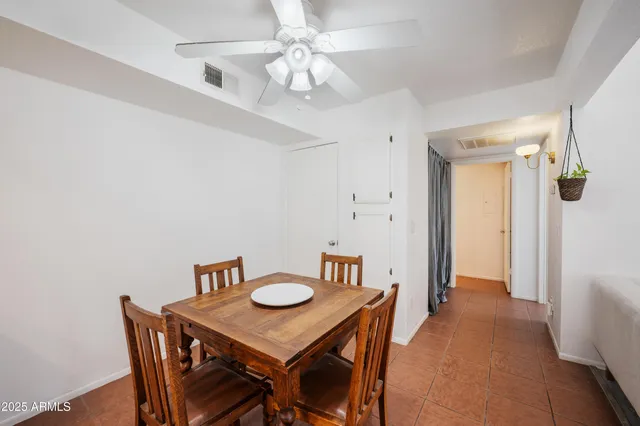 a view of a dining room with furniture and a chandelier