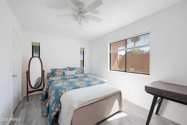 a bedroom with bed and a chandelier