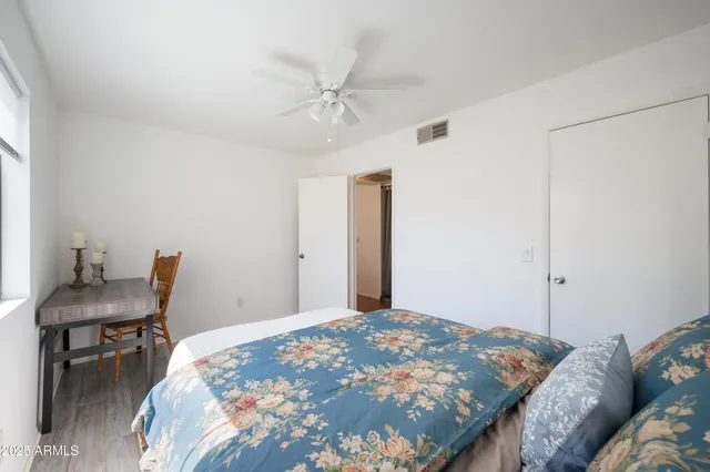 a bedroom with a bed a desk and chair