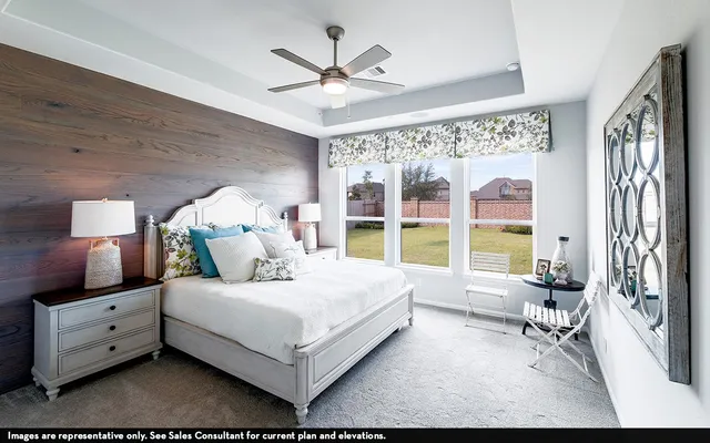 a bedroom with a large bed and a large window