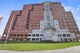 750 Davol Street, Unit 616 Fall River, MA 02720 - Photo 2 of 17 a large building with a yard