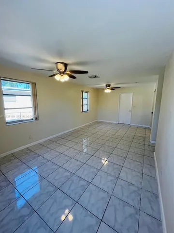 a kitchen with a refrigerator a sink and cabinets